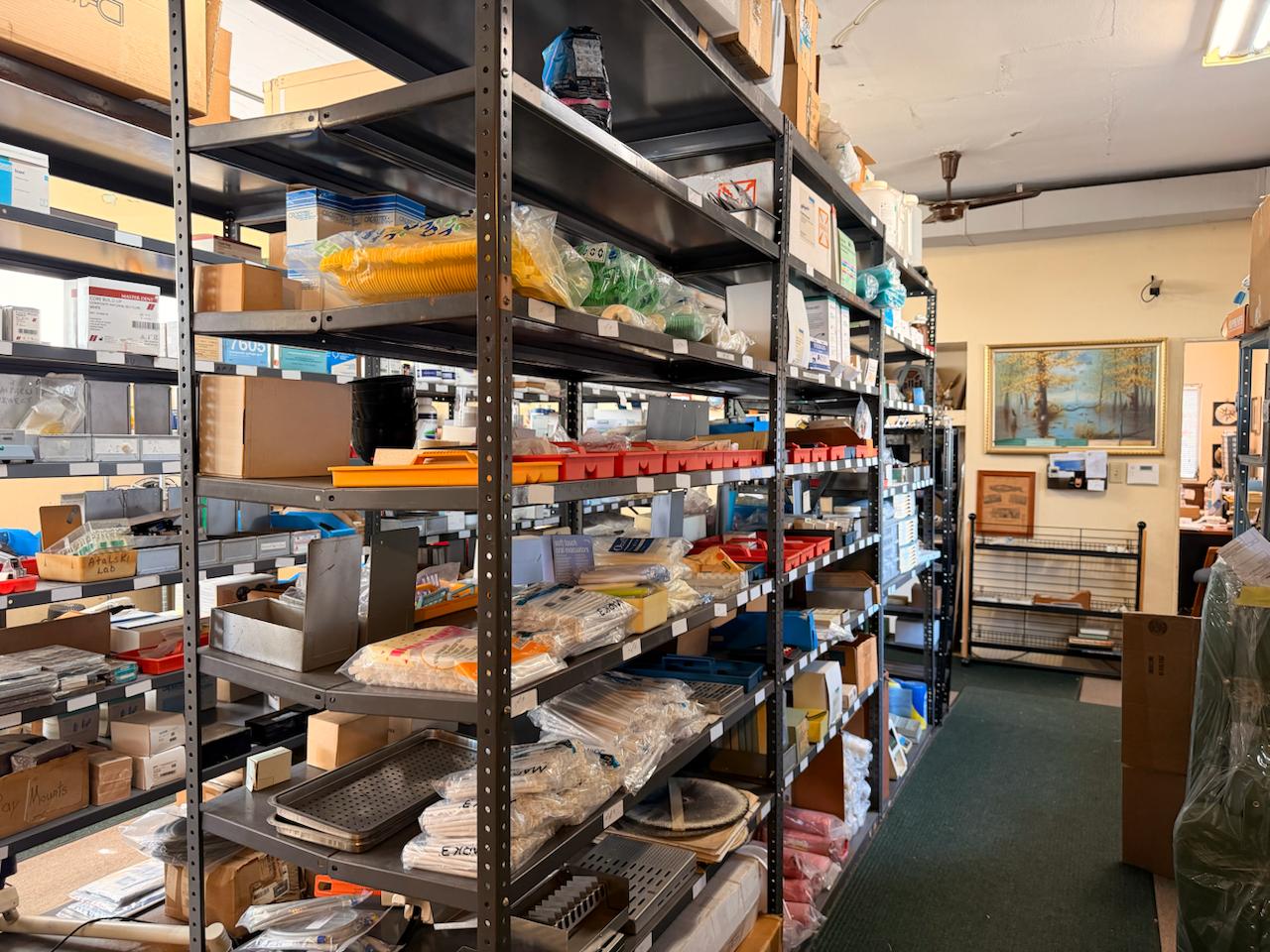 Dental supply shelves packed with instruments and supplies